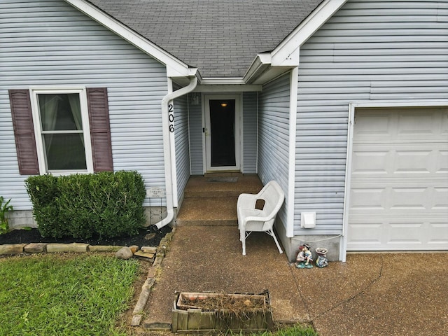 206 Cross Valley Dr, Columbia, TN 38401 - view of exterior entry with a shingled roof and an attached garage