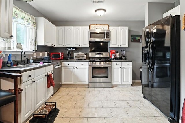 206 Cross Valley Dr, Columbia, TN 38401 - kitchen with appliances with stainless steel finishes, dark countertops, and white cabinets