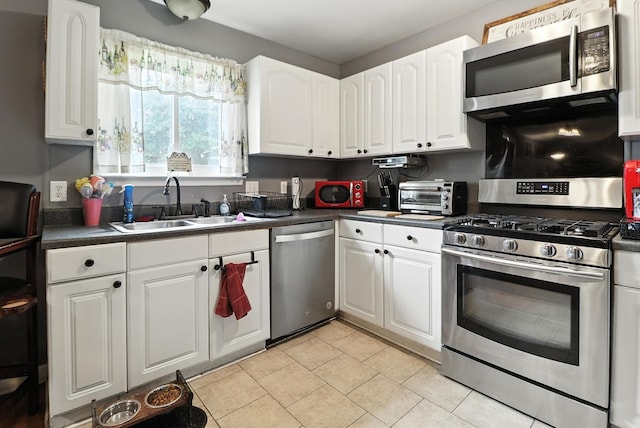 206 Cross Valley Dr, Columbia, TN 38401 - kitchen with appliances with stainless steel finishes, dark countertops, white cabinets, and light tile patterned floors