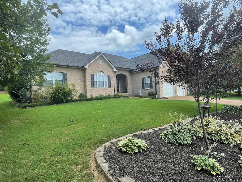2814 New Port Royal Rd, Thompsons Station, TN 37179 - view of front of house with a front lawn, a garage, brick siding, and concrete driveway
