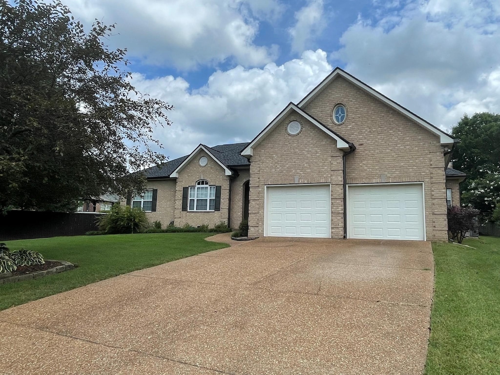 2814 New Port Royal Rd, Thompsons Station, TN 37179 - view of front facade featuring brick siding, concrete driveway, a front yard, and a garage
