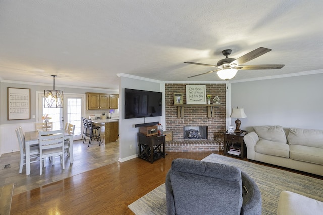 127 Fisherdale Dr, Decaturville, TN 38329 - living area with a ceiling fan, ornamental molding, wood finished floors, a fireplace, and a textured ceiling