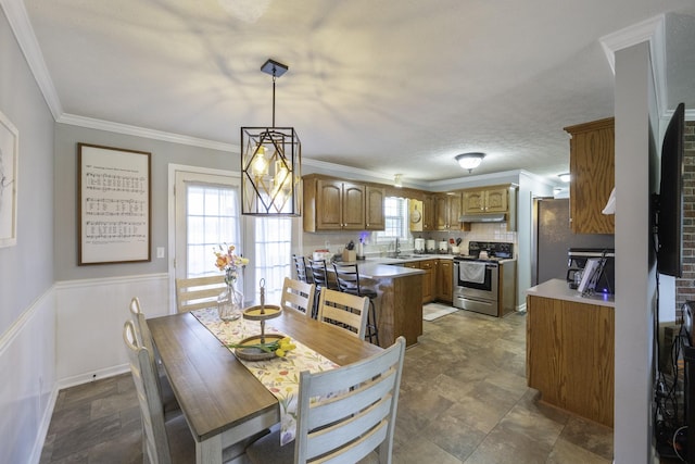 127 Fisherdale Dr, Decaturville, TN 38329 - dining area featuring stone finish floors, wainscoting, and ornamental molding