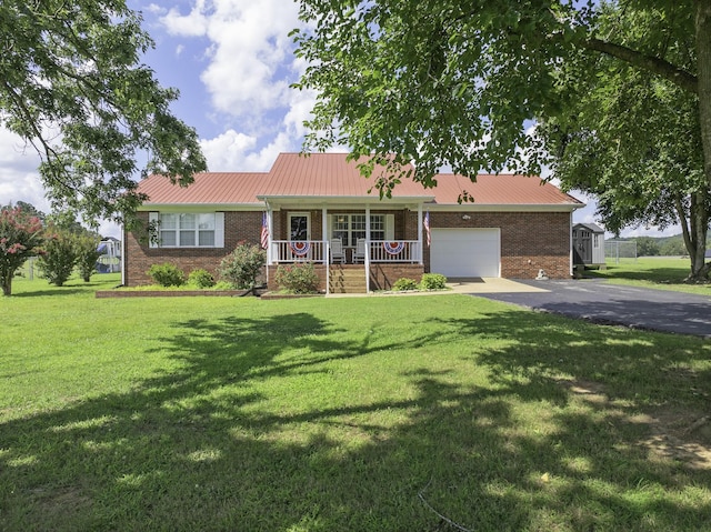127 Fisherdale Dr, Decaturville, TN 38329 - ranch-style home featuring covered porch, brick siding, asphalt driveway, an attached garage, and a front yard