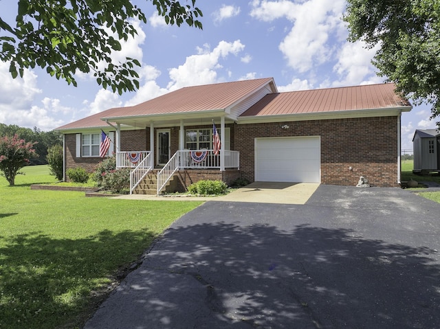 127 Fisherdale Dr, Decaturville, TN 38329 - ranch-style home with brick siding, a porch, asphalt driveway, a garage, and a metal roof