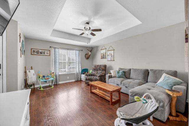 261 Golden Pond Ave, Oak Grove, KY 42262 - living area featuring a tray ceiling, ceiling fan, and dark wood-style floors