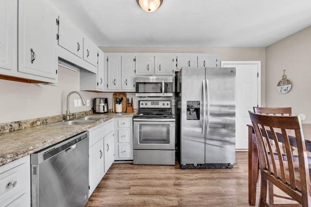 261 Golden Pond Ave, Oak Grove, KY 42262 - kitchen featuring appliances with stainless steel finishes, white cabinets, and light wood-type flooring