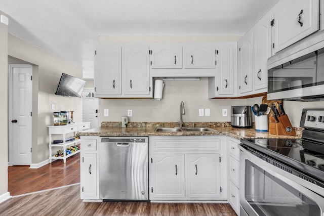 261 Golden Pond Ave, Oak Grove, KY 42262 - kitchen featuring stainless steel appliances, wood finished floors, white cabinetry, and dark stone countertops
