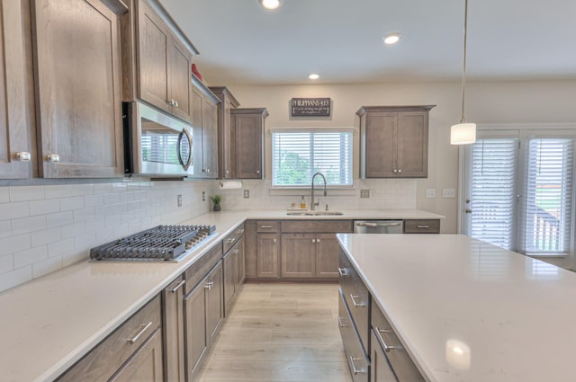 2064 Hedgelawn Dr, Lebanon, TN 37090 - kitchen with stainless steel appliances, light wood-style floors, tasteful backsplash, recessed lighting, and light countertops