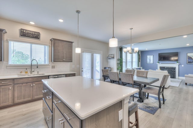 2064 Hedgelawn Dr, Lebanon, TN 37090 - kitchen featuring light wood-type flooring, open floor plan, backsplash, light countertops, and recessed lighting