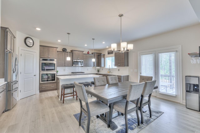 2064 Hedgelawn Dr, Lebanon, TN 37090 - dining area with a chandelier, light wood-type flooring, and recessed lighting