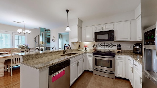 281 Glenstone Cir, Brentwood, TN 37027 - kitchen with stainless steel appliances, a peninsula, white cabinetry, and a chandelier