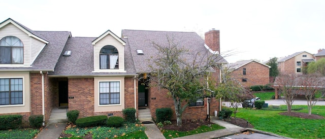 281 Glenstone Cir, Brentwood, TN 37027 - cape cod house featuring brick siding, a front yard, roof with shingles, and a chimney