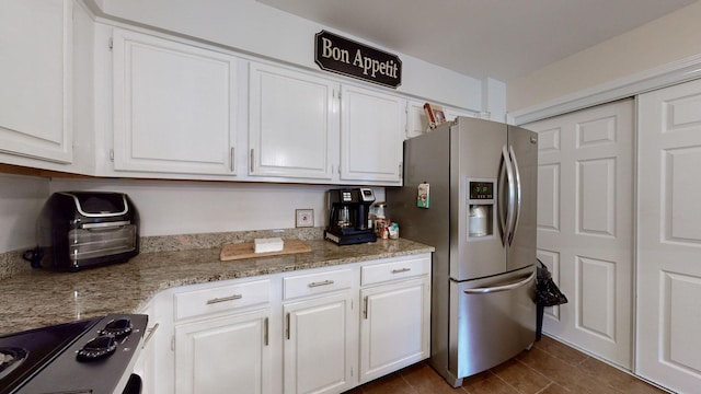 281 Glenstone Cir, Brentwood, TN 37027 - kitchen featuring stainless steel fridge, white cabinets, range, and light stone counters