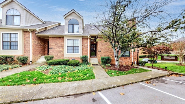 281 Glenstone Cir, Brentwood, TN 37027 - view of front facade with uncovered parking, brick siding, and a shingled roof