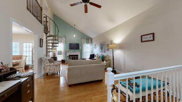 281 Glenstone Cir, Brentwood, TN 37027 - living room with high vaulted ceiling, ceiling fan, light wood-style flooring, and a glass covered fireplace