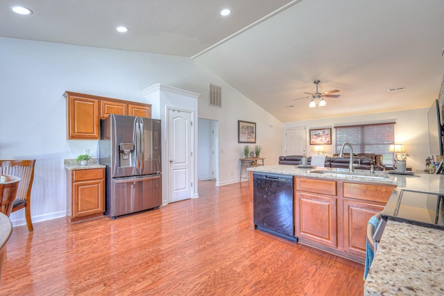1005 Lark Ct, Spring Hill, TN 37174 - kitchen featuring stainless steel appliances, vaulted ceiling, brown cabinetry, ceiling fan, and light wood finished floors
