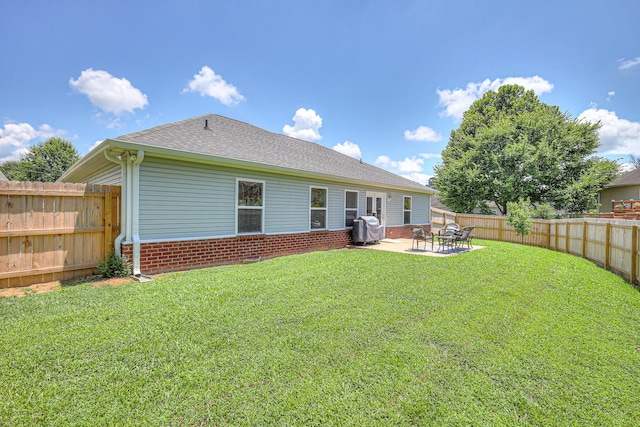 1005 Lark Ct, Spring Hill, TN 37174 - rear view of house with a fenced backyard, brick siding, a patio area, and a shingled roof