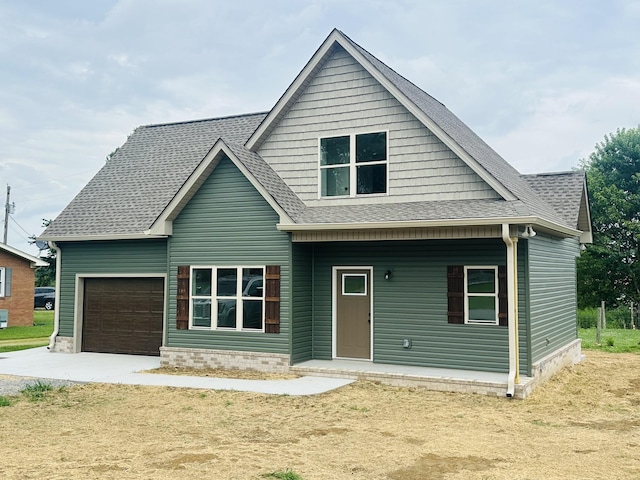 1108 Flippin Dr, Lafayette, TN 37083 - view of front of house with an attached garage, driveway, and a shingled roof
