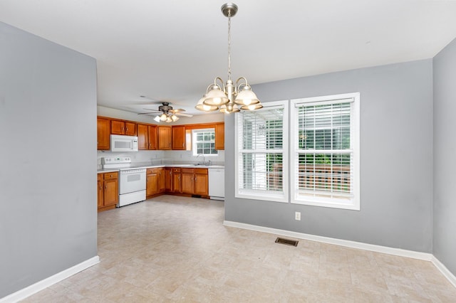 381 Bailey Ln, Pleasant View, TN 37146 - kitchen with white appliances, light countertops, a chandelier, brown cabinetry, and pendant lighting