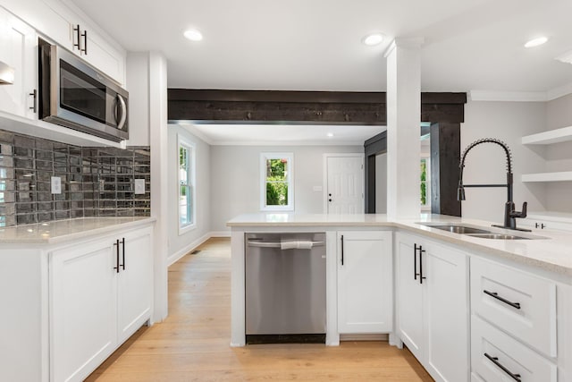 310 E Highland Dr, Columbia, TN 38401 - kitchen featuring appliances with stainless steel finishes, decorative backsplash, light stone countertops, white cabinets, and ornamental molding