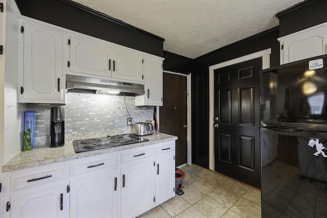 55 Lancaster Ln, Parsons, TN 38363 - kitchen featuring under cabinet range hood, black electric stovetop, decorative backsplash, white cabinetry, and light countertops