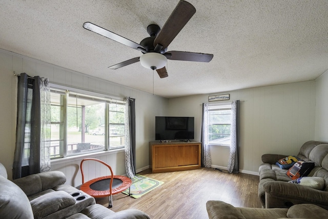 55 Lancaster Ln, Parsons, TN 38363 - living room with light wood finished floors, a textured ceiling, and a ceiling fan