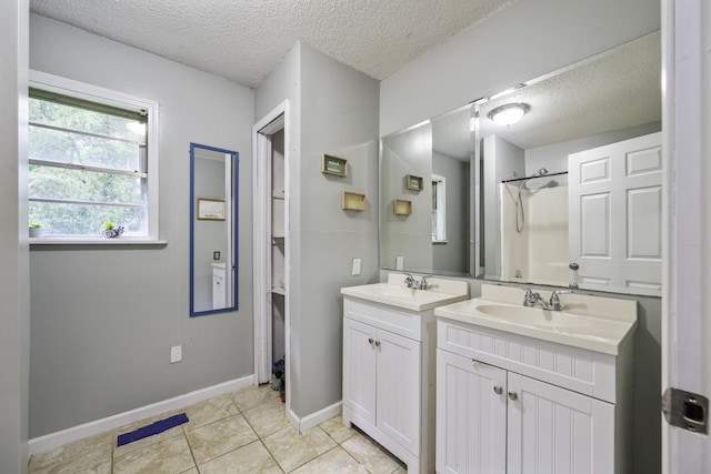 55 Lancaster Ln, Parsons, TN 38363 - bathroom featuring a textured ceiling, two vanities, tile patterned floors, and a shower