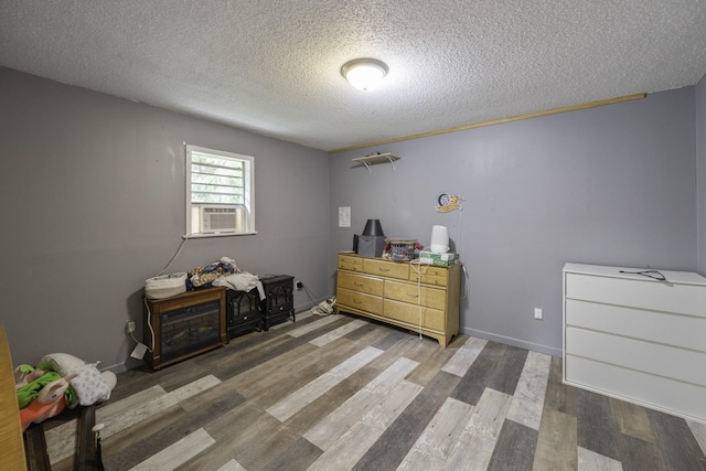 55 Lancaster Ln, Parsons, TN 38363 - bedroom with a textured ceiling, cooling unit, and wood finished floors