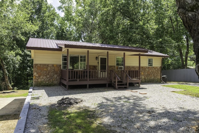 55 Lancaster Ln, Parsons, TN 38363 - view of front of home with stone siding, a porch, and a metal roof