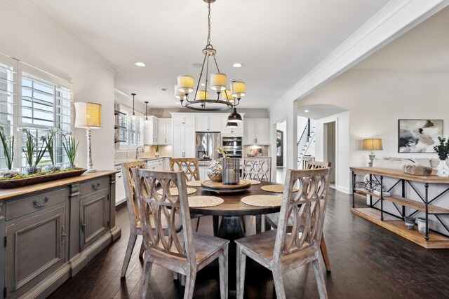4376 Pretoria Run, Murfreesboro, TN 37128 - dining space with arched walkways, dark wood-style flooring, a chandelier, ornamental molding, and recessed lighting