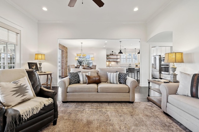 4376 Pretoria Run, Murfreesboro, TN 37128 - living room featuring a ceiling fan, wood finished floors, recessed lighting, ornamental molding, and a chandelier