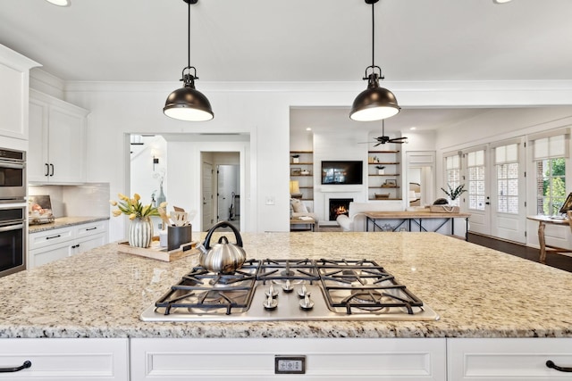 4376 Pretoria Run, Murfreesboro, TN 37128 - kitchen featuring stainless steel appliances, white cabinets, light stone counters, open floor plan, and recessed lighting