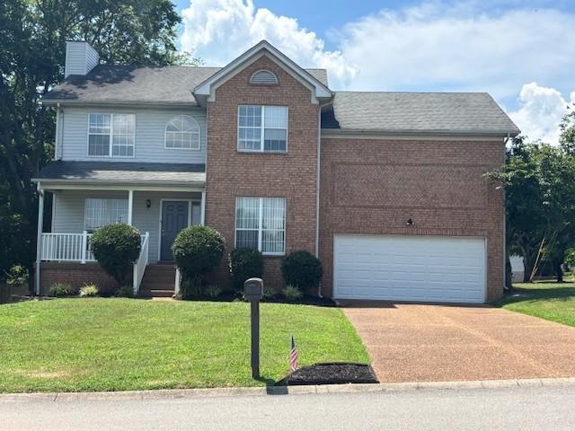 1327 Sydney Ter, Mount Juliet, TN 37122 - traditional-style house featuring brick siding, a chimney, concrete driveway, a front yard, and a garage