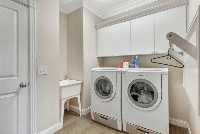 1660 Stokley Ln, Old Hickory, TN 37138 - laundry room with washing machine and dryer, ornamental molding, cabinet space, and light wood-type flooring