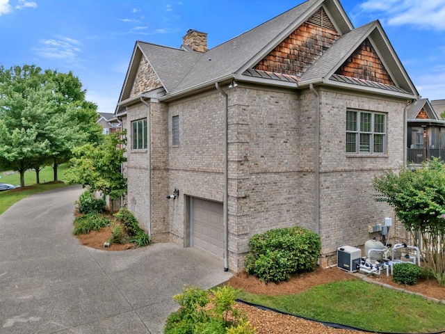 1660 Stokley Ln, Old Hickory, TN 37138 - view of property exterior with driveway, an attached garage, brick siding, and a standing seam roof