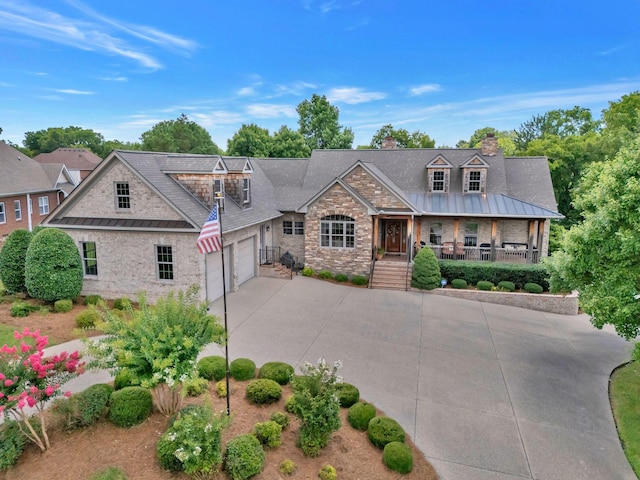 1660 Stokley Ln, Old Hickory, TN 37138 - view of front of property featuring stone siding, driveway, a garage, covered porch, and a chimney