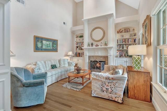 1660 Stokley Ln, Old Hickory, TN 37138 - living room featuring high vaulted ceiling, wood finished floors, a premium fireplace, and built in features
