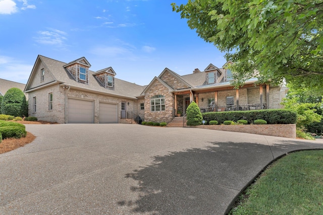 1660 Stokley Ln, Old Hickory, TN 37138 - view of front of house with brick siding, concrete driveway, covered porch, roof with shingles, and an attached garage