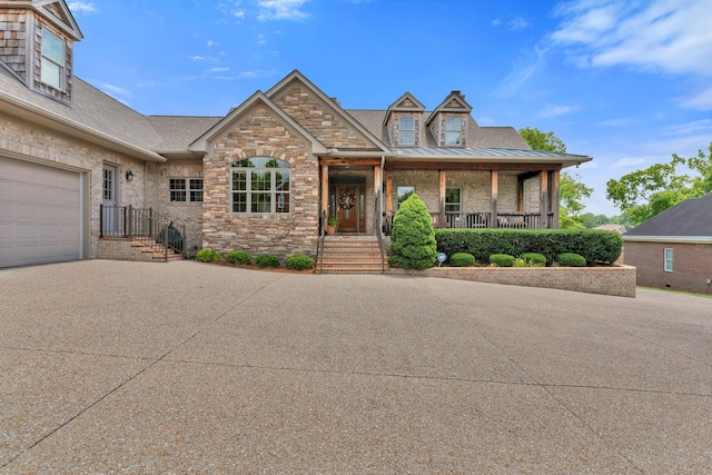 1660 Stokley Ln, Old Hickory, TN 37138 - view of front of property featuring concrete driveway, a garage, covered porch, stone siding, and a shingled roof