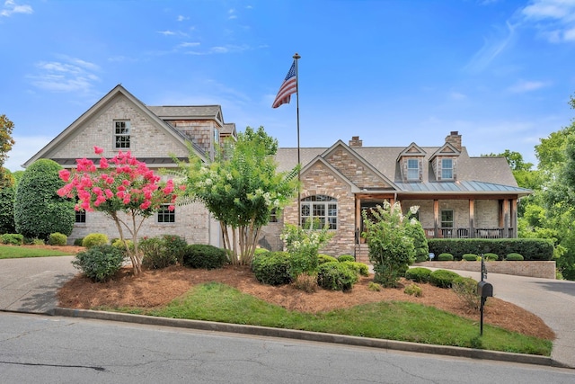 1660 Stokley Ln, Old Hickory, TN 37138 - view of front of home featuring covered porch, brick siding, a chimney, and a standing seam roof