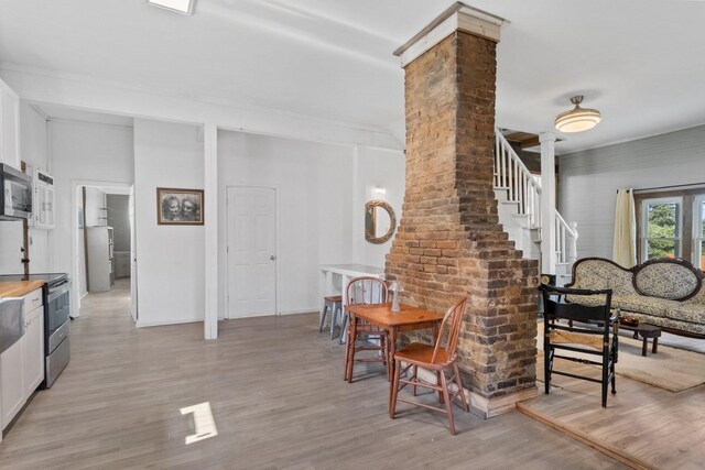 584 Limestone Ave, Lewisburg, TN 37091 - dining room with light wood-type flooring, stairway, and ornate columns