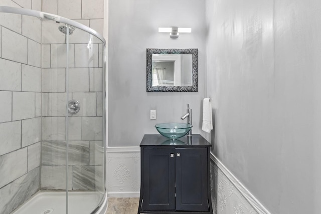 584 Limestone Ave, Lewisburg, TN 37091 - bathroom featuring a stall shower, vanity, a wainscoted wall, and wood finished floors