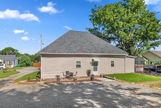 584 Limestone Ave, Lewisburg, TN 37091 - back of property featuring driveway, a shingled roof, and a patio area