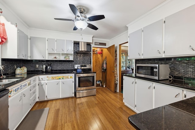 1148 Green Valley Dr, Lewisburg, TN 37091 - kitchen with appliances with stainless steel finishes, wall chimney range hood, tasteful backsplash, light wood-style flooring, and ornamental molding