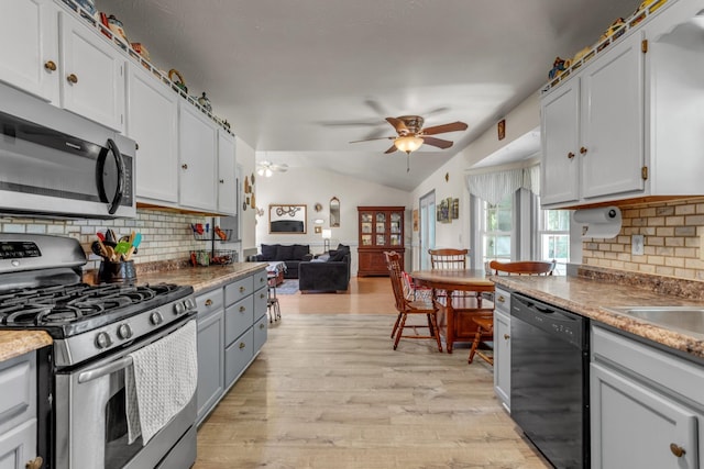 1530 Potter Dr, Columbia, TN 38401 - kitchen with appliances with stainless steel finishes, a ceiling fan, light wood-type flooring, tasteful backsplash, and lofted ceiling