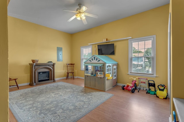 1530 Potter Dr, Columbia, TN 38401 - recreation room featuring a ceiling fan, wood finished floors, a glass covered fireplace, and electric panel