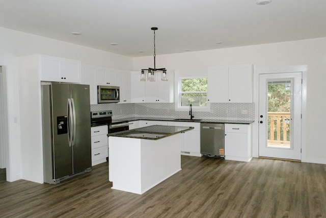 3119 Country Side Dr, Centerville, TN 37033 - kitchen with stainless steel appliances, dark wood finished floors, tasteful backsplash, and white cabinets