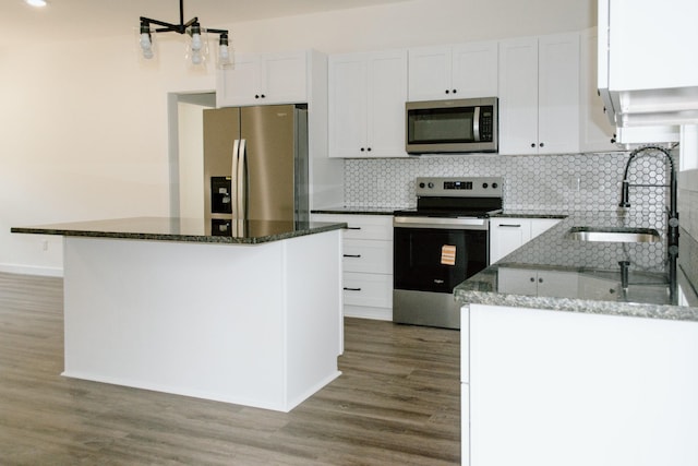 3119 Country Side Dr, Centerville, TN 37033 - kitchen with appliances with stainless steel finishes, white cabinets, backsplash, and light wood finished floors