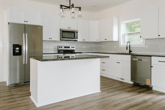 3119 Country Side Dr, Centerville, TN 37033 - kitchen with appliances with stainless steel finishes, a center island, white cabinets, backsplash, and dark stone countertops